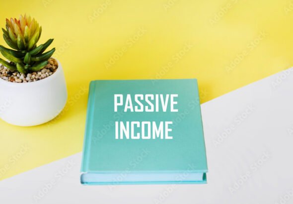 Green notepad with passive income text on a yellow and white background. BUSINESS CONCEPT