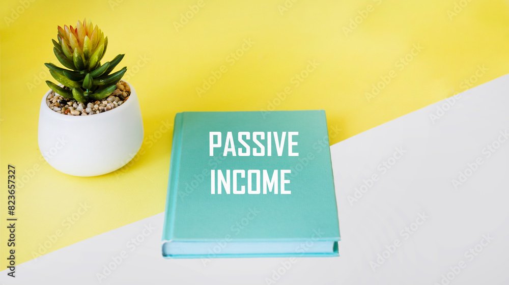 Green notepad with passive income text on a yellow and white background. BUSINESS CONCEPT