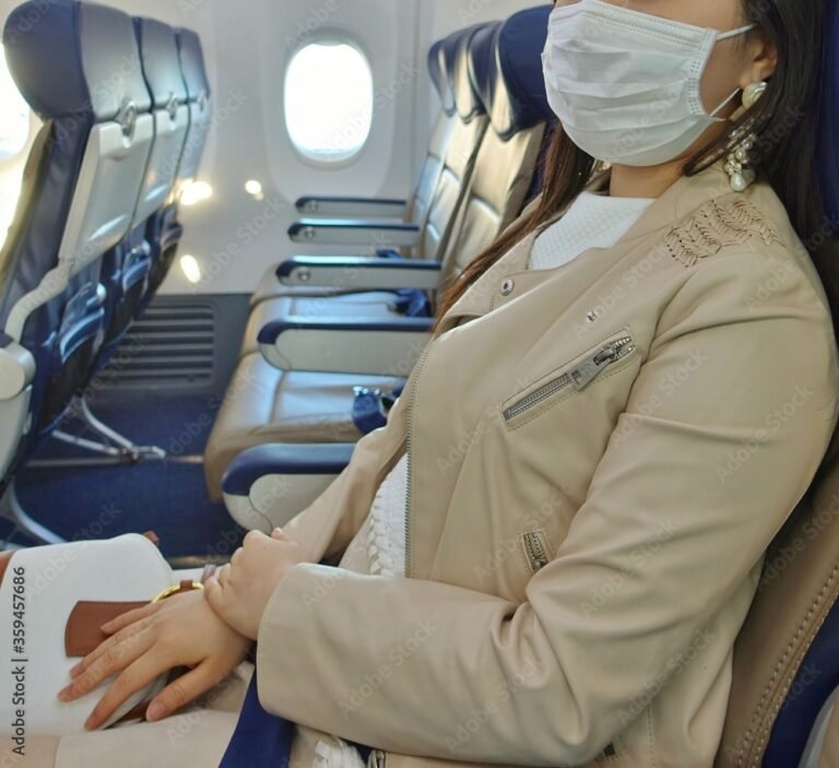 PHILADELPHIA, PA -13 JUN 2020- View of a woman wearing a face mask during the COVID-19 crisis in the empty cabin of an airplane from Southwest Airlines (WN).